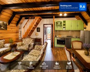 a living room with green cabinets and a kitchen at White pine cottage in Motički Gaj