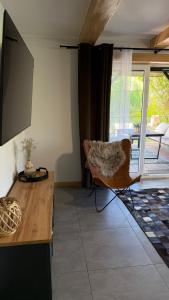 a living room with a table and a chair at Gajówka in Istebna