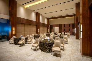 a banquet hall with tables and chairs in a room at Tree of Life Ganga Dwar, Haridwar in Haridwār +76 photos