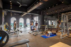 a gym with a woman doing a push up in the gym at Tree of Life Ganga Dwar, Haridwar in Haridwār