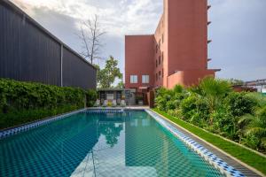 a swimming pool in front of a building at Tree of Life Ganga Dwar, Haridwar in Haridwār