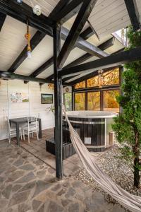 a hammock in the middle of a screened in porch at Cabana Diana in Avrig