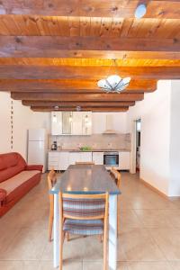 a kitchen and living room with a table and chairs at Cabana Diana in Avrig