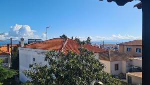 a view of roofs of houses and a tree at MUSHROOMs1 AFYTOS in Afitos