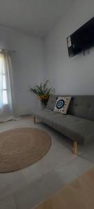 a living room with a couch and a television at MUSHROOMs1 AFYTOS in Afitos