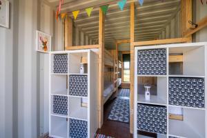 a room with white shelves and a door in a room at Container 1, Camp Tapnell in Yarmouth