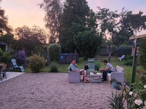 two men sitting in chairs in a garden at L'étoile du matin in Terville +109 photos