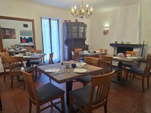 a dining room with tables and chairs and a piano at La Locanda del Gusto in Cadro +34 photos
