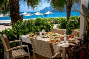 a table with food on it with a view of the beach at Villa Lukka in Cıralı