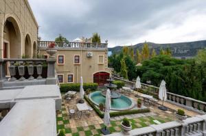 an outdoor patio with a fountain and a building at IL Castello Boutique Hotel in Clarens