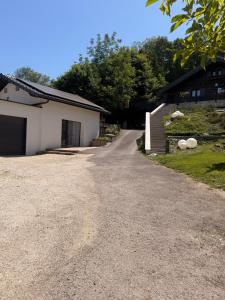 a driveway leading to a building with a garage at L apparte Sciez in Sciez