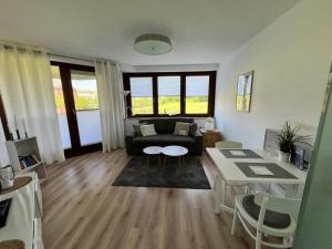 a living room with a couch and a table at Erholung im Trave Kieker 004 mit Pool und Sauna in Lübeck
