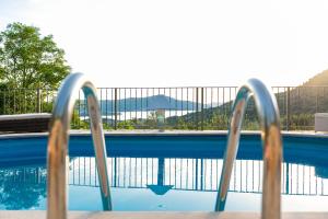 a view of a swimming pool with two metal rails at Sunset Holiday Home in Tivat