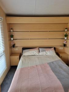 a bedroom with a large bed with a wooden headboard at The View in Millom