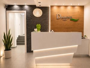 a white counter in a store with a sign on the wall at B&b Diamond in San Vito lo Capo