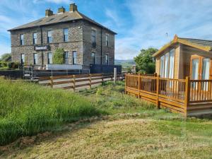 a house with a wooden fence next to a building at The View in Millom