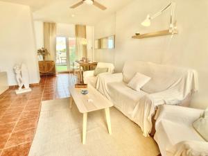 a living room with a white couch and a table at Spanish Connection - Las Amoladeras in Cabo de Palos