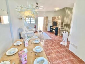 a living room with a table with plates on it at Spanish Connection - Las Amoladeras in Cabo de Palos +15 photos