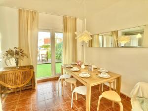 a dining room with a wooden table and chairs at Spanish Connection - Las Amoladeras in Cabo de Palos