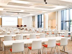 a room with white tables and chairs and a whiteboard at Novotel Monte-Carlo in Monte Carlo +170 photos