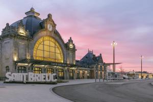 a large building with a clock on top of it at BayView in Saint-Brieuc +8 photos