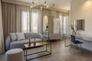 a living room with a couch and a table at PERATZADA central suite in Argostoli +16 photos