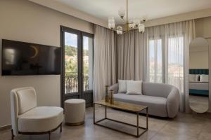 a living room with a couch and a chair at PERATZADA central suite in Argostoli
