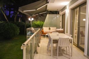 a patio with a table and chairs and a couch at Blue Coast Villa -Perla Resort in Lalëz