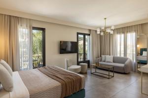 a bedroom with a bed and a living room at PERATZADA central suite in Argostoli