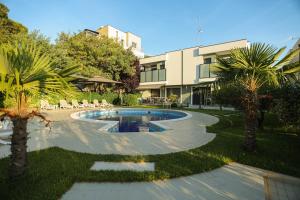 a courtyard with a pool in front of a building at Blue Coast Villa -Perla Resort in Lalëz