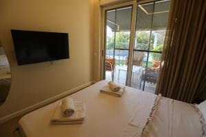 a room with a table with two towels on it at Blue Coast Villa -Perla Resort in Lalëz +93 photos