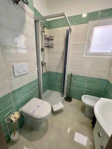 a bathroom with a shower and a toilet and a sink at Affittacamere La bottega del barbiere in Scalea +33 photos