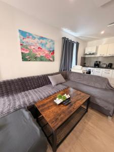 a living room with a couch and a table at Apartmán Provence in Doksy