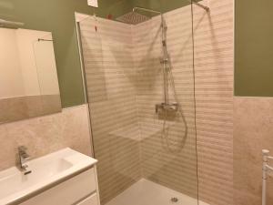 a shower with a glass door next to a sink at Le Lenze in Pozzilli