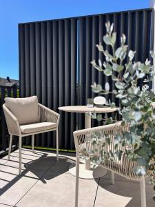a patio with two chairs and a table and a fence at Haus Knechtel in Stadtallendorf