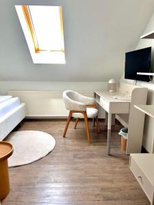a room with a desk and a chair and a computer at Haus Knechtel in Stadtallendorf
