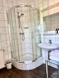 a bathroom with a shower and a sink at Haus Knechtel in Stadtallendorf +5 photos
