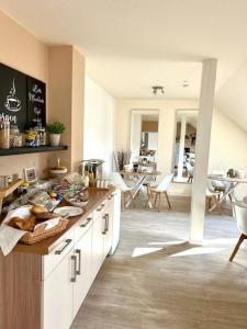 a kitchen with a counter and a dining room at Haus Knechtel in Stadtallendorf