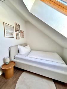 a small bed in a room with a staircase at Haus Knechtel in Stadtallendorf