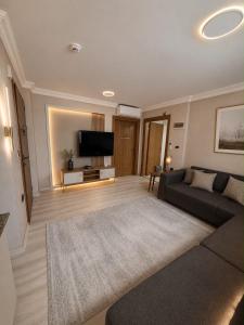 a living room with a couch and a flat screen tv at Trabzon Albayrak Suite in Trabzon