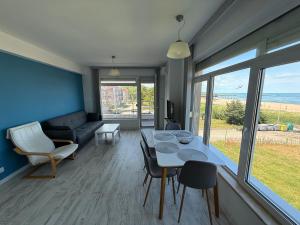 a living room with a table and chairs and a couch at Апартамент Солана - Apartment Solana in Lozenets