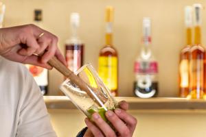 a person is stirring a drink with a stick at Evoras Boutique Hotel in Xirokámbion +34 photos