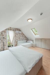 a bedroom with a white bed and a window at Casa Diana Confort in Avrig