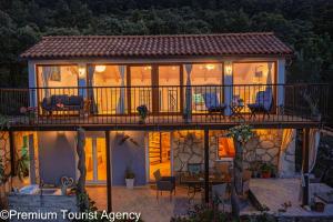 a house with a deck with chairs on it at Hidden Beach Villa Biankura in Smokvica +14 photos