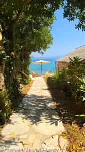 a path leading to a beach with an umbrella at Hidden Beach Villa Biankura in Smokvica