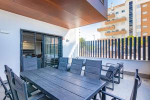 a wooden table and chairs on a balcony at Adhara - 034 in Torre del Mar
