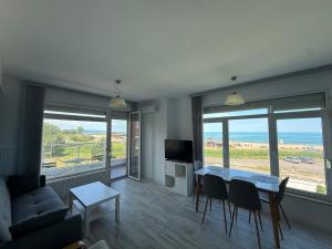 a living room with a couch and a table with chairs at Апартамент Солана - Apartment Solana in Lozenets