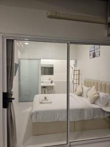 a bedroom with a bed and a sink in it at Treat Boutique HuaHin 94 in Hua Hin