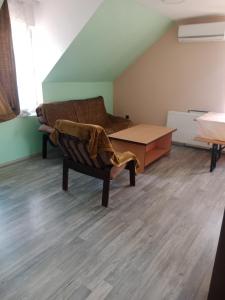 a living room with a couch and a table at Juzna Prica in Ćuprija