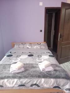 a bedroom with a bed with two towels on it at Juzna Prica in Ćuprija